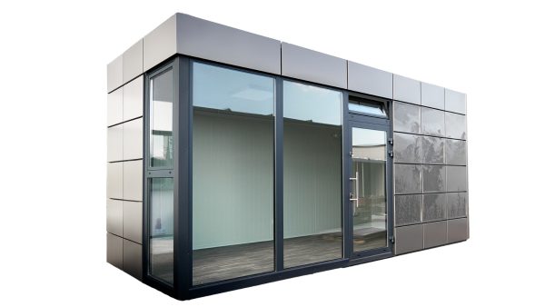 Bürocontainer mit einer Fassade aus glatten Metallplatten und großen Glasflächen inkl. breiter Glasfront im linken vorderen Bereich in einer seitlichen Vorderansicht